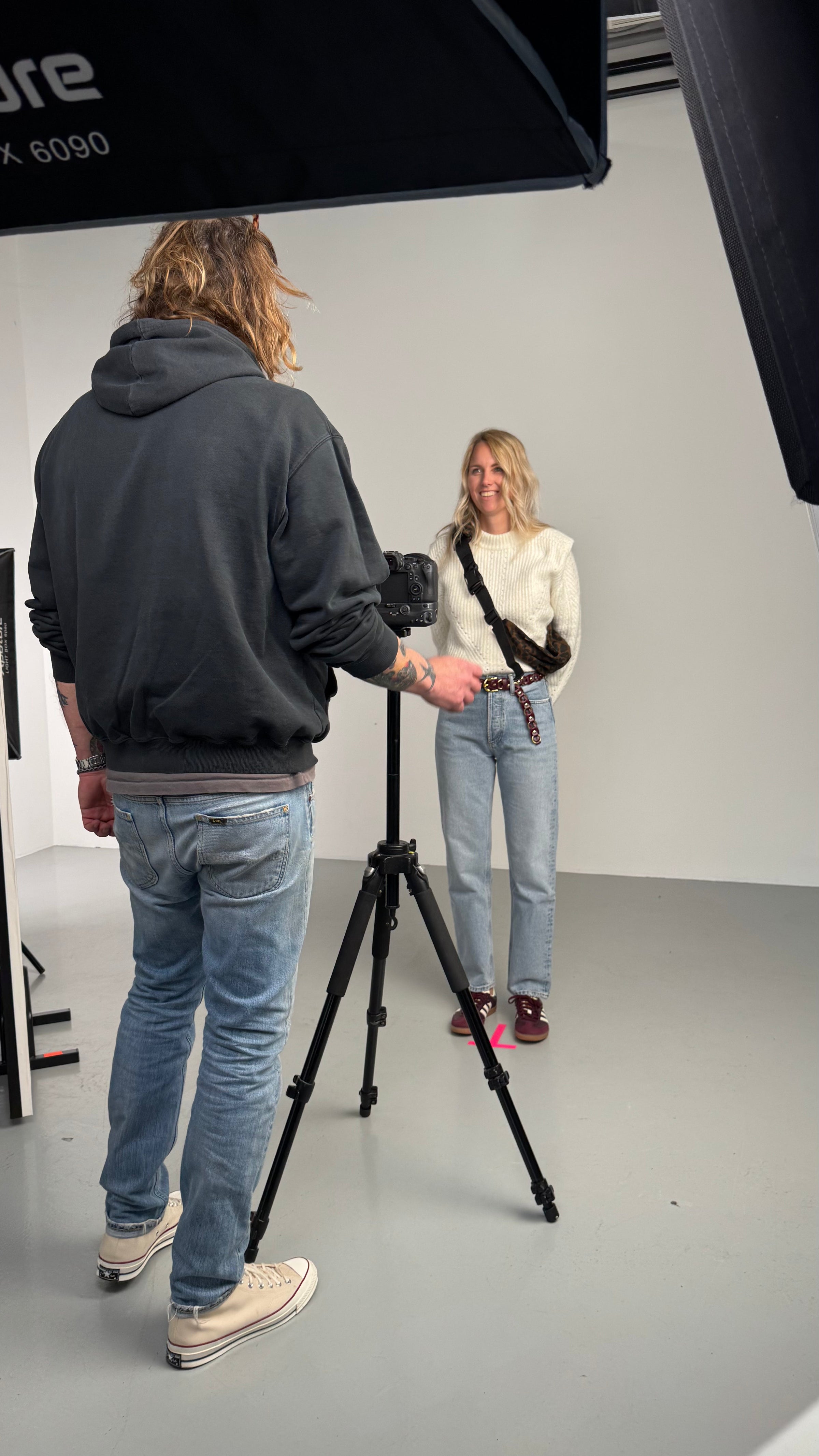 Behind-the-scenes of a Wildride toddler carrier photoshoot, featuring a parent carrying a child in a hip carrier. The outdoor setting captures the spirit of adventure, comfort, and connection that defines the best baby carrier experience.