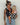 wildride houndstooth teddy toddler carrier — mom carrying child on hip against white wall